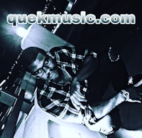 a man sitting on the ground with the words quickmusic com