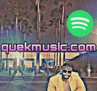 a man sitting on a bench in front of a palm tree